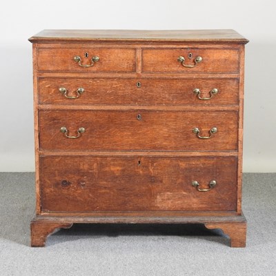 Lot 527 - A George III oak chest of drawers, on bracket...