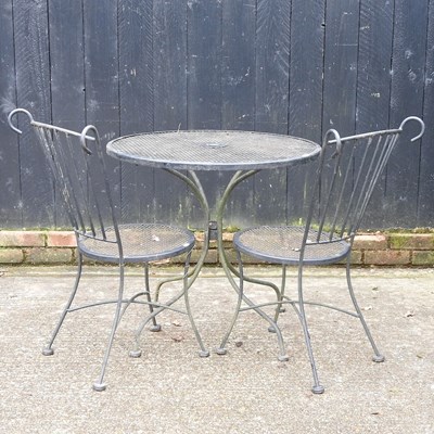 Lot 540 - An iron garden table, together with two chairs...