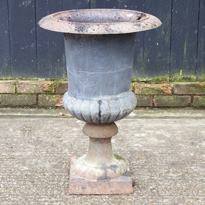 Lot 61 - A black painted cast iron campana shaped...