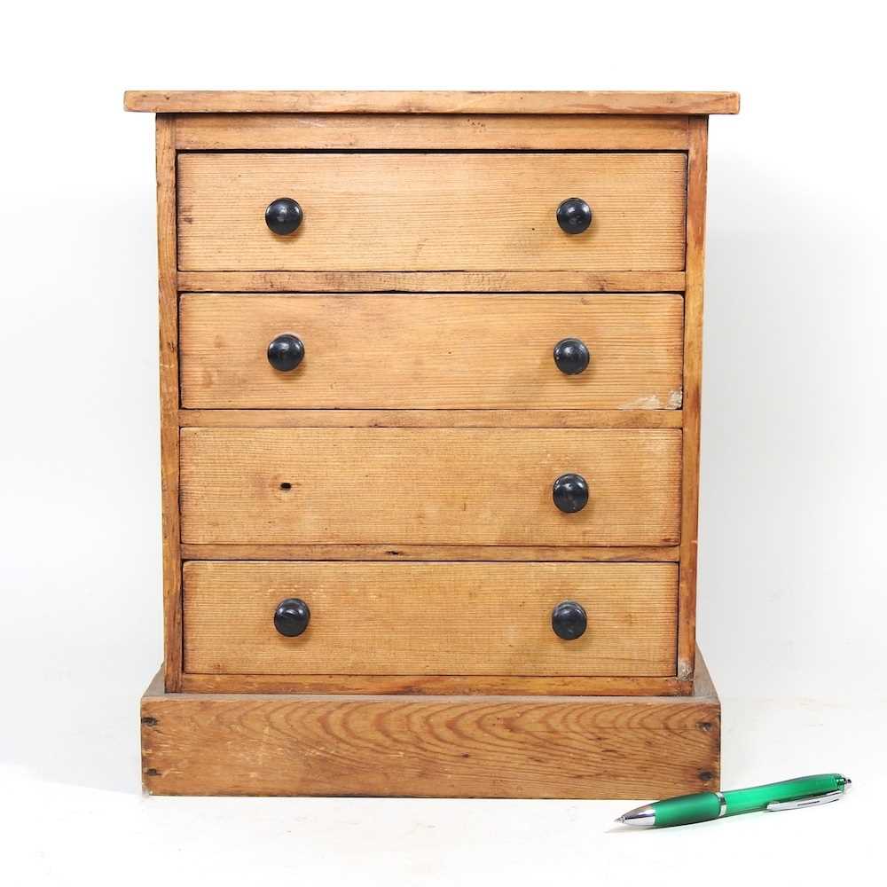 Lot 27 - A Victorian pine miniature chest, containing...