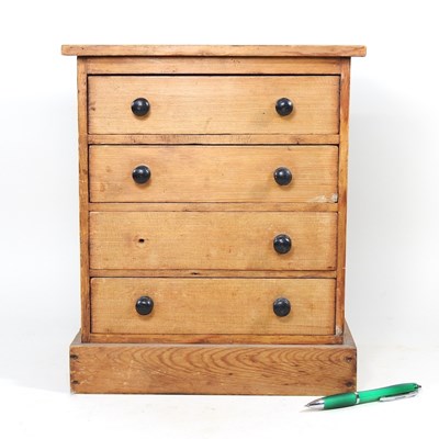 Lot 27 - A Victorian pine miniature chest, containing...