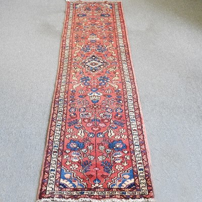 Lot 815 - A Persian Sarouk runner, with foliate designs,...