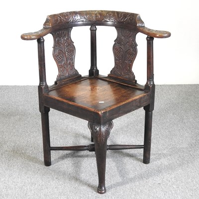 Lot 571 - A George III and later carved oak corner chair