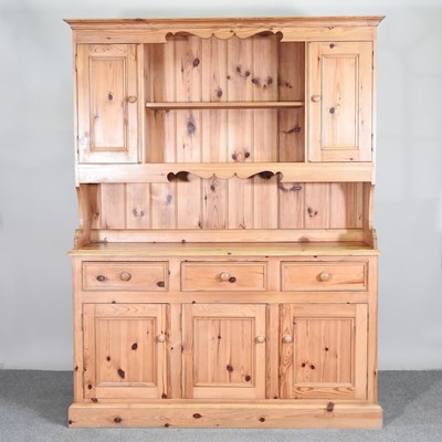 Lot 453 - A modern pine dresser, with a boarded back, on...