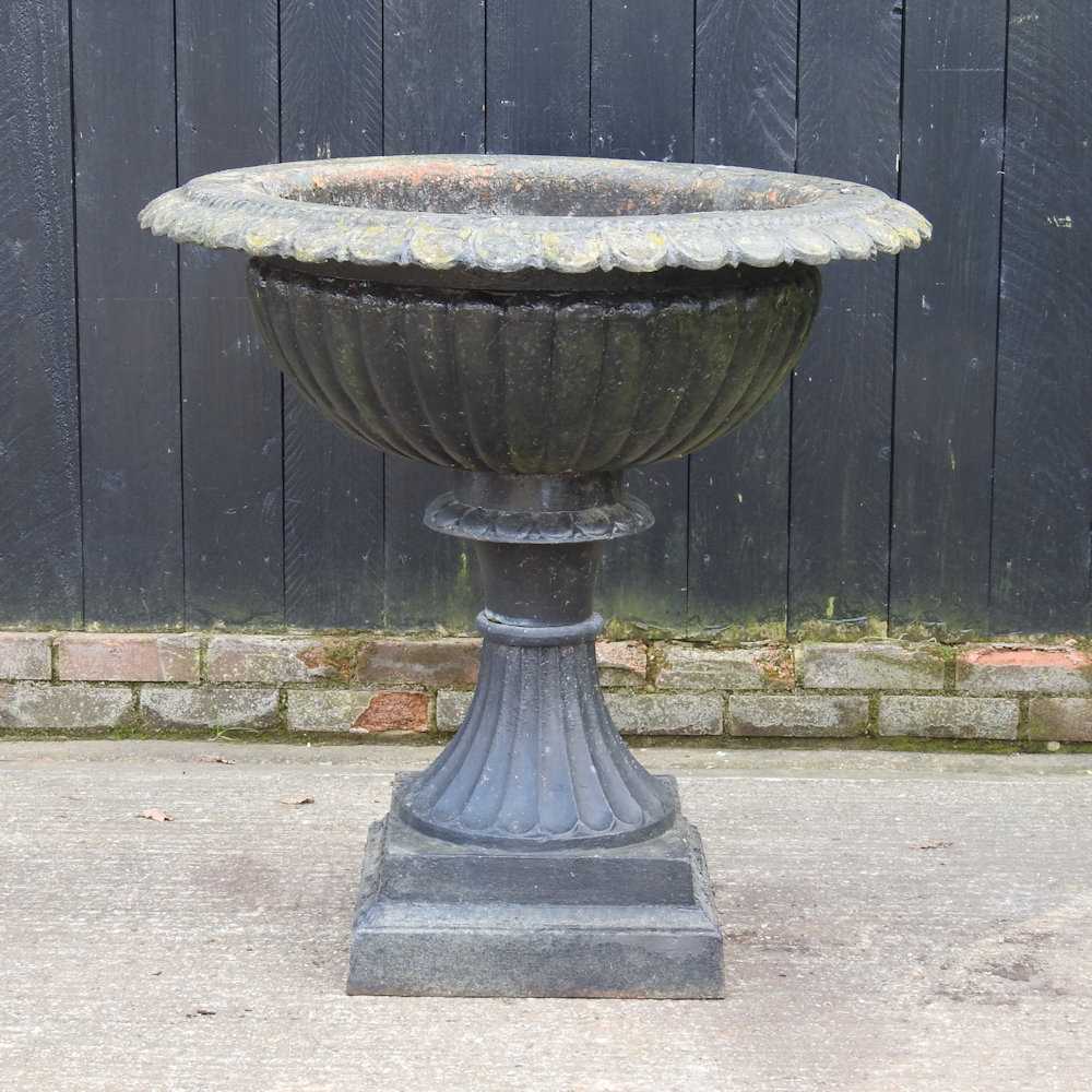 Lot 35 - A large black painted cast iron garden planter,...