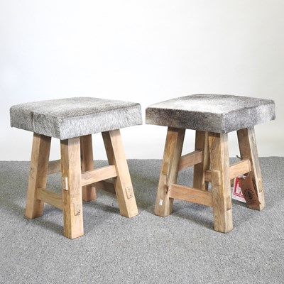 Lot 298 - A pair of cowhide upholstered footstools (2)