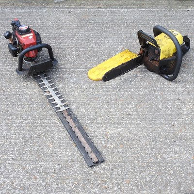 Lot 506 - A petrol chainsaw, together with a petrol...