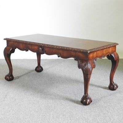 Lot 552 - A 1930's walnut coffee table on claw and ball...