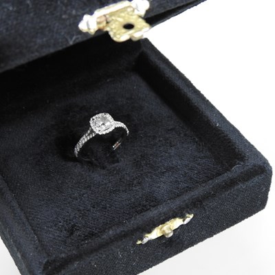 Lot 14 - A platinum and diamond halo ring, the central...