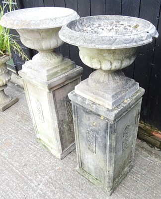 Lot 11 - A pair of large cast stone garden urns, each...