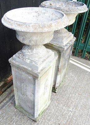 Lot 11 - A pair of large cast stone garden urns, each...