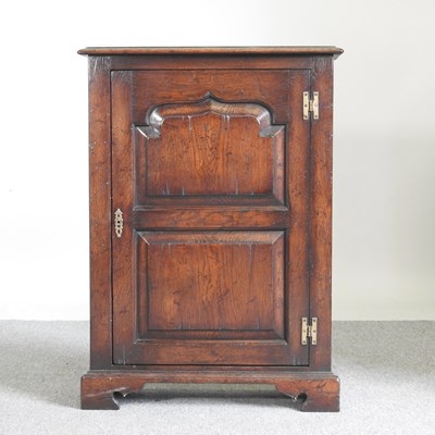 Lot 512 - An 18th century oak narrow cabinet, 20th...