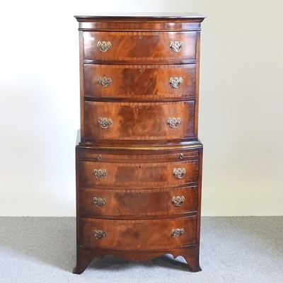 Lot 400 - A mid 20th century bow front tall boy chest,...