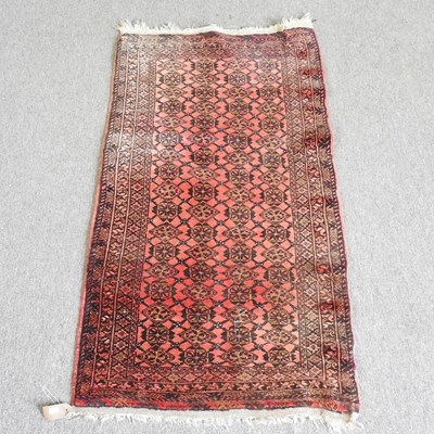 Lot 499 - An Afghan rug, with rows of medallions, on a...