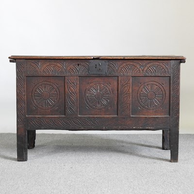 Lot 425 - An 18th century oak coffer, with a carved...