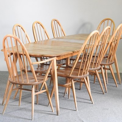 Lot 533 - A 1960's Ercol light elm dining table, with an...