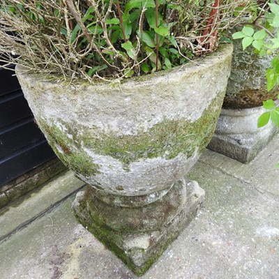 Lot 22 - A pair of large cast stone garden pots, each...