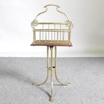 Lot 560 - An early 20th century oak and brass magazine...