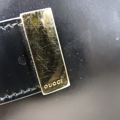 Lot 19 - A Gucci black leather tote handbag, with...
