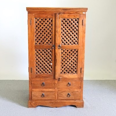 Lot 539 - An Eastern hardwood side cabinet, enclosed by...