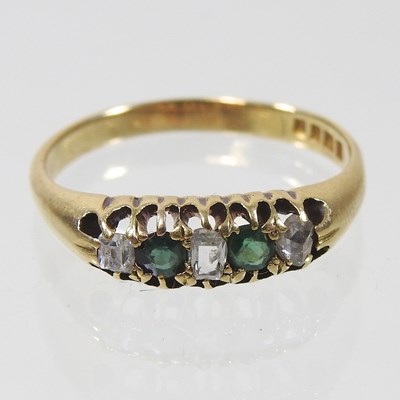 Lot 316 - An 18 carat gold emerald and diamond five...