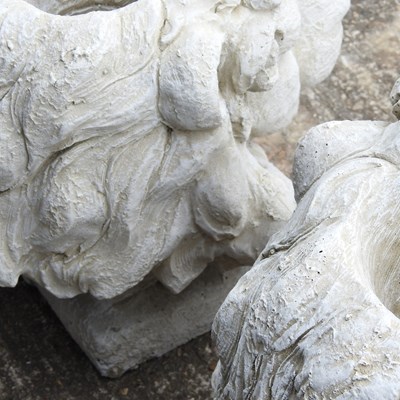 Lot 128 - A pair of cast stone lion mask garden planters,...