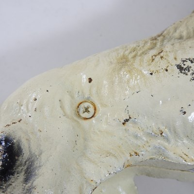 Lot 15 - A painted cast iron door stop, in the form of...