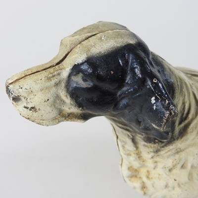 Lot 15 - A painted cast iron door stop, in the form of...