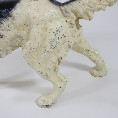 Lot 15 - A painted cast iron door stop, in the form of...