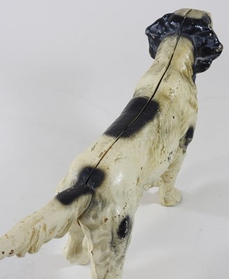 Lot 15 - A painted cast iron door stop, in the form of...