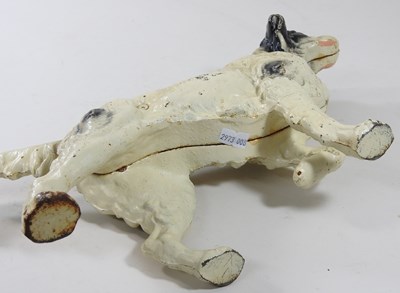 Lot 15 - A painted cast iron door stop, in the form of...