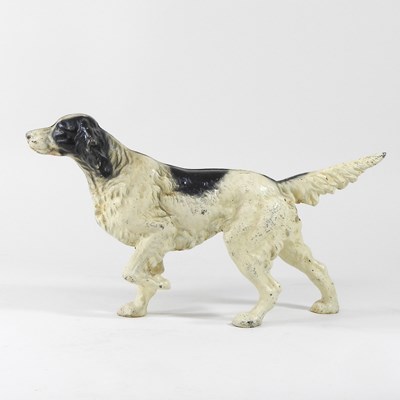 Lot 15 - A painted cast iron door stop, in the form of...