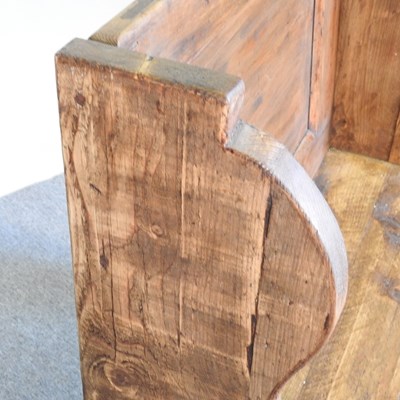 Lot 39 - A hand made pine pew, with a panelled back and...