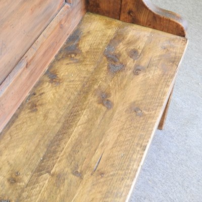 Lot 39 - A hand made pine pew, with a panelled back and...
