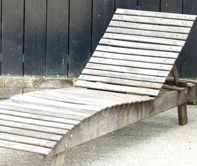 Lot 43 - A teak adjustable garden lounger, 183cm long