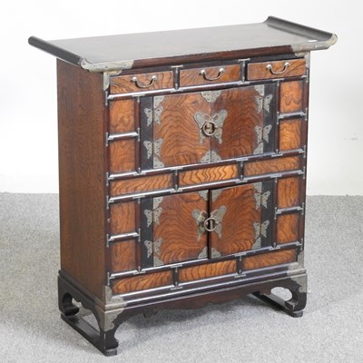 Lot 22 - A small Chinese elm cabinet, with drawers and...