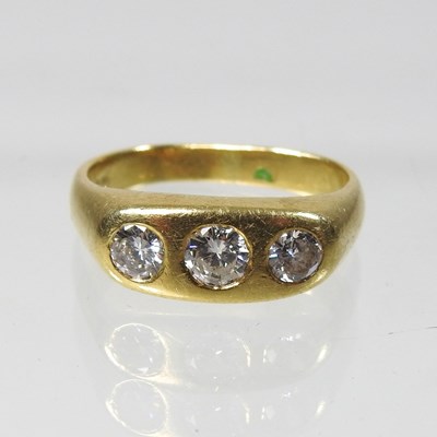 Lot 19 - An 18 carat gold three stone diamond ring
