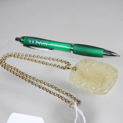 Lot 42 - A Chinese jade pendant, fret carved with two...