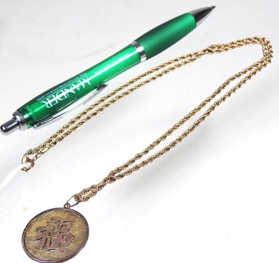 Lot 68 - A Chinese two colour gilt dragon coin pendant,...