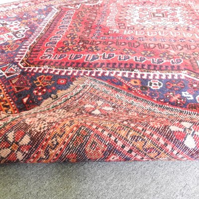 Lot 120 - A Persian Shiraz rug, with a central hooked...