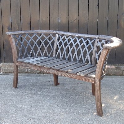 Lot 297 - A wooden garden bench, with a lattice back,...