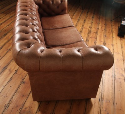 Lot 37 - A tan leather buttoned upholstered...