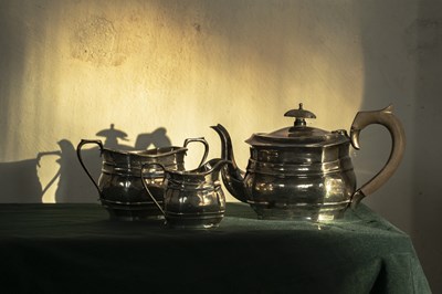 Lot 61 - A George V silver harlequin three-piece tea...