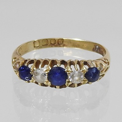 Lot 41 - An 18 carat gold five stone sapphire and diamond ring
