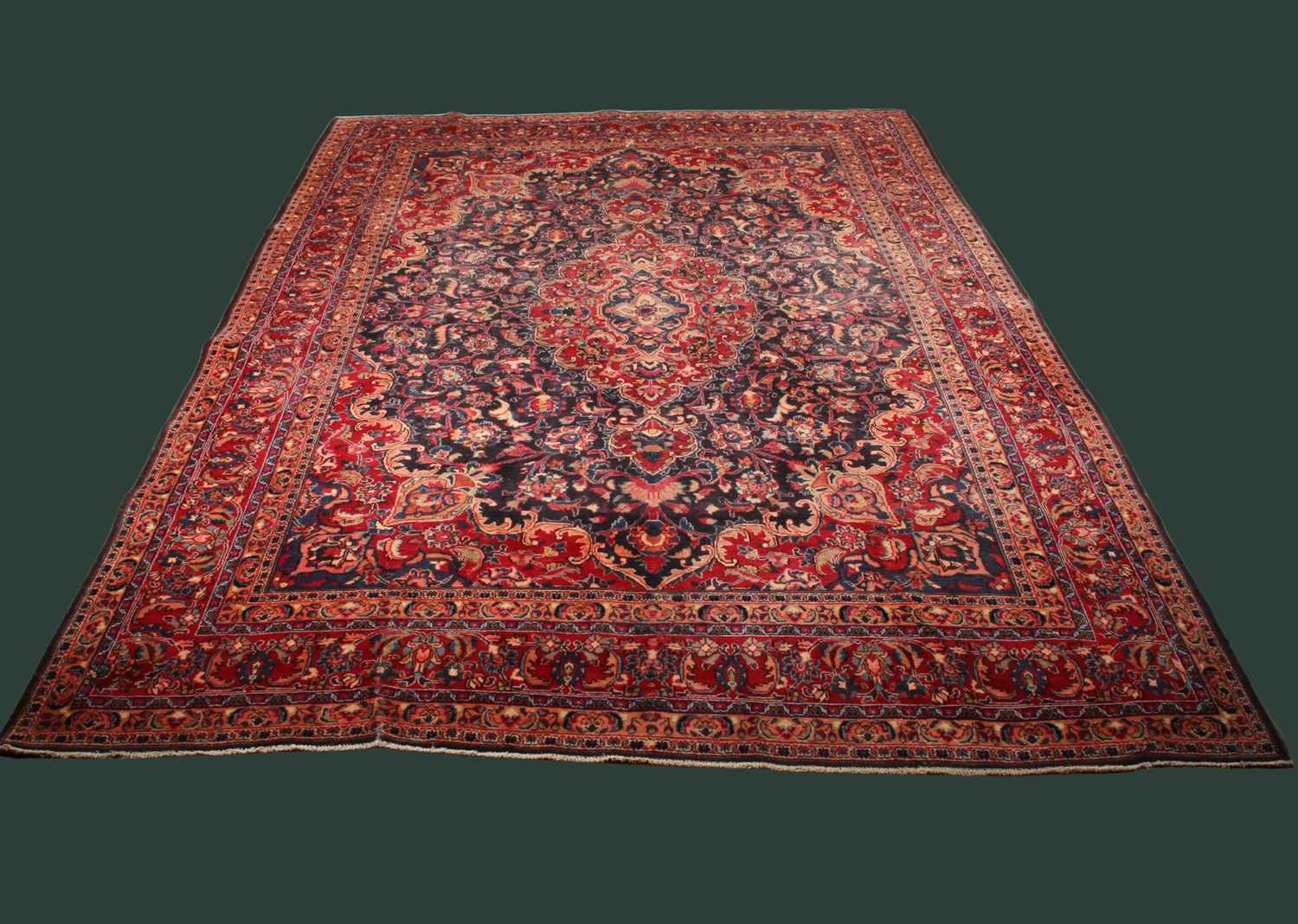 Lot 14 - A large Persian Tabriz woollen rug, the...