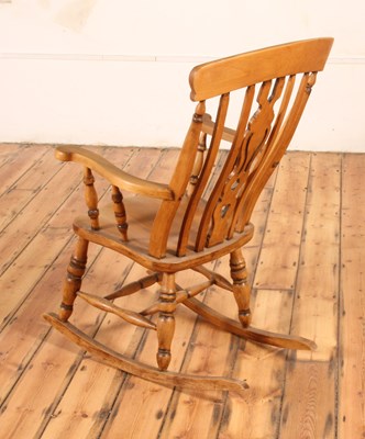 Lot 48 - A beech farmhouse rocking chair, 20th century,...