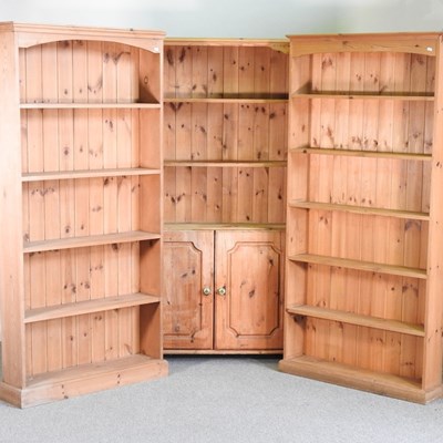 Lot 114 - A near pair of pine standing open bookcases,...