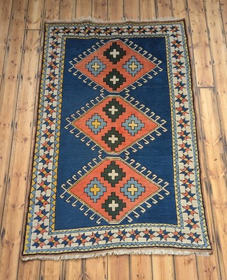 Lot 484 - A Turkish rug, having three medallions on a...