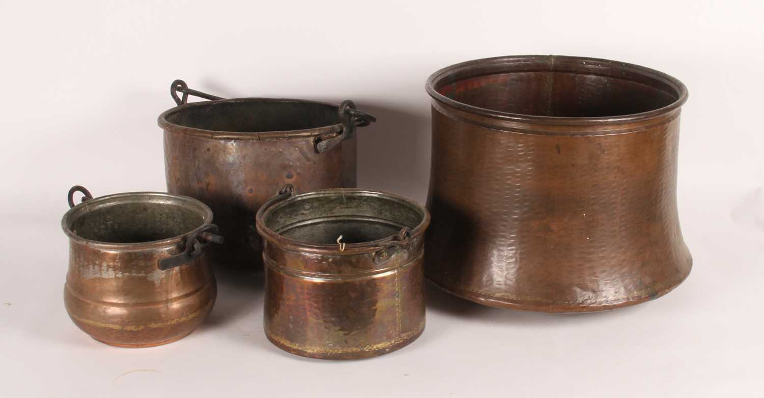 Lot 54 - Four copper cauldrons, varying sizes, largest...
