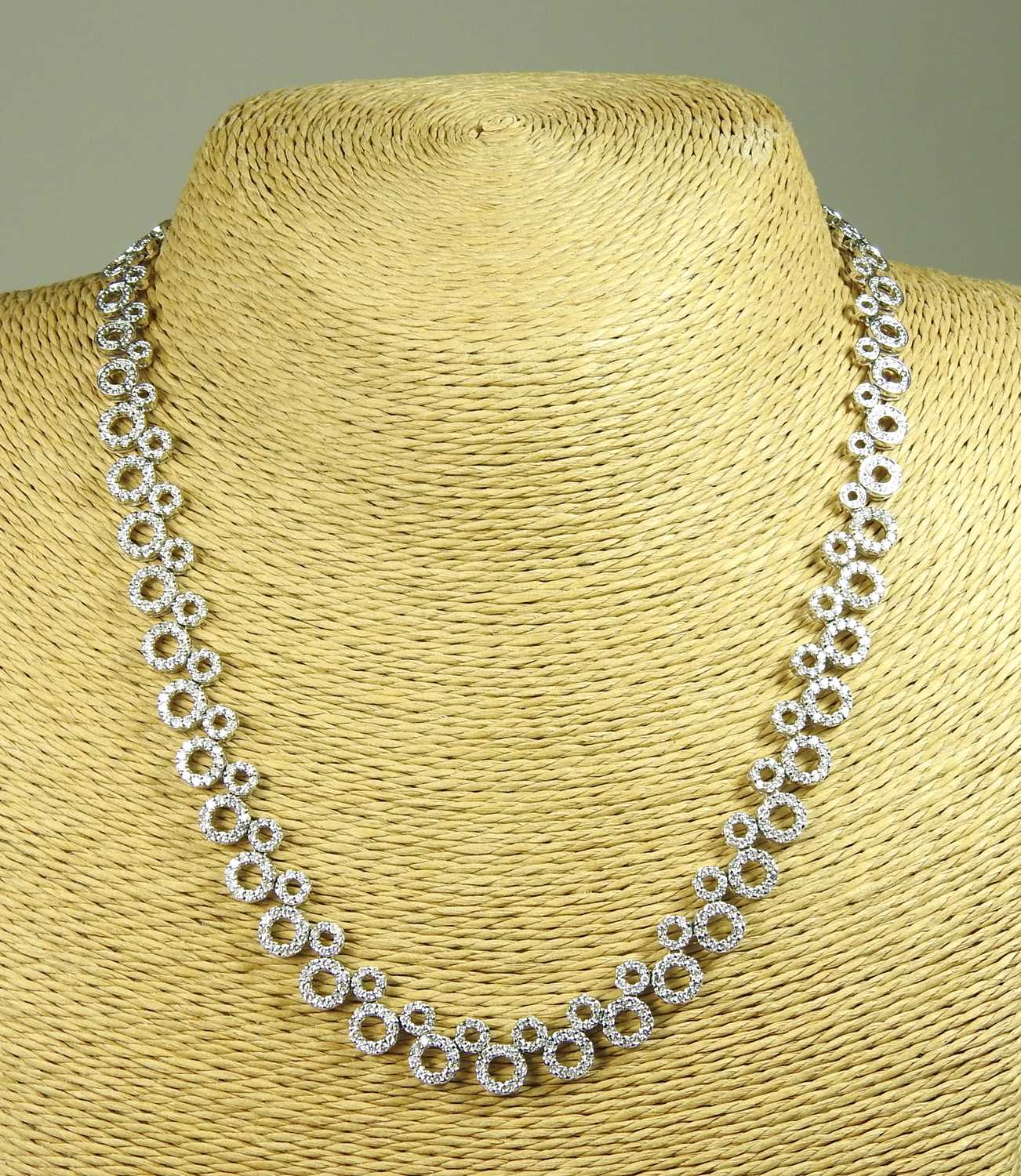 Lot 58 - An 18 carat white gold and diamond set...